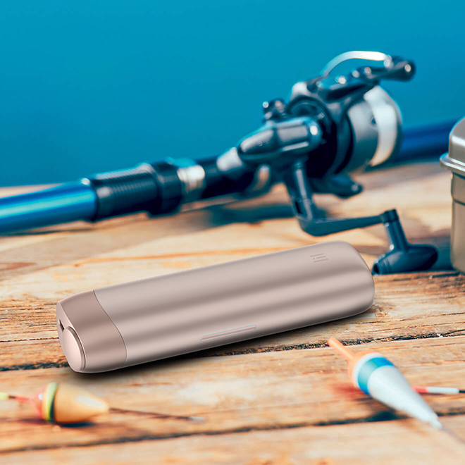 lil SOLID Ez device on wooden table next to fishing gear