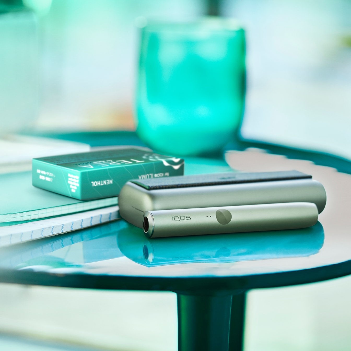 An IQOS Holder and Pocket Charger on a side table.